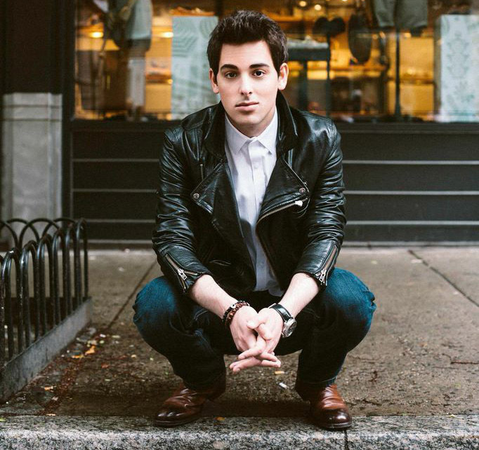 Jackson Harris crouching in a leather jacket and jeans. Photo credit: Mike Lerner