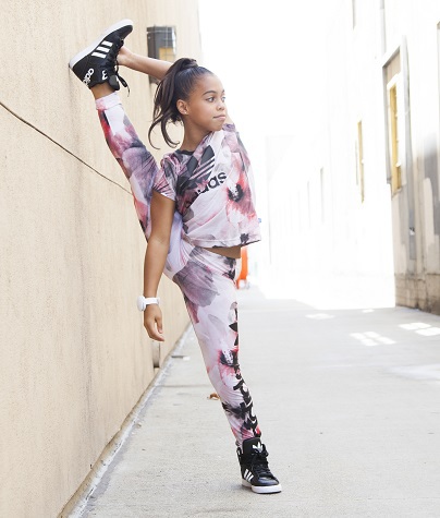 Asia Monet Ray showing off her flexibility in her Adidas track suit.