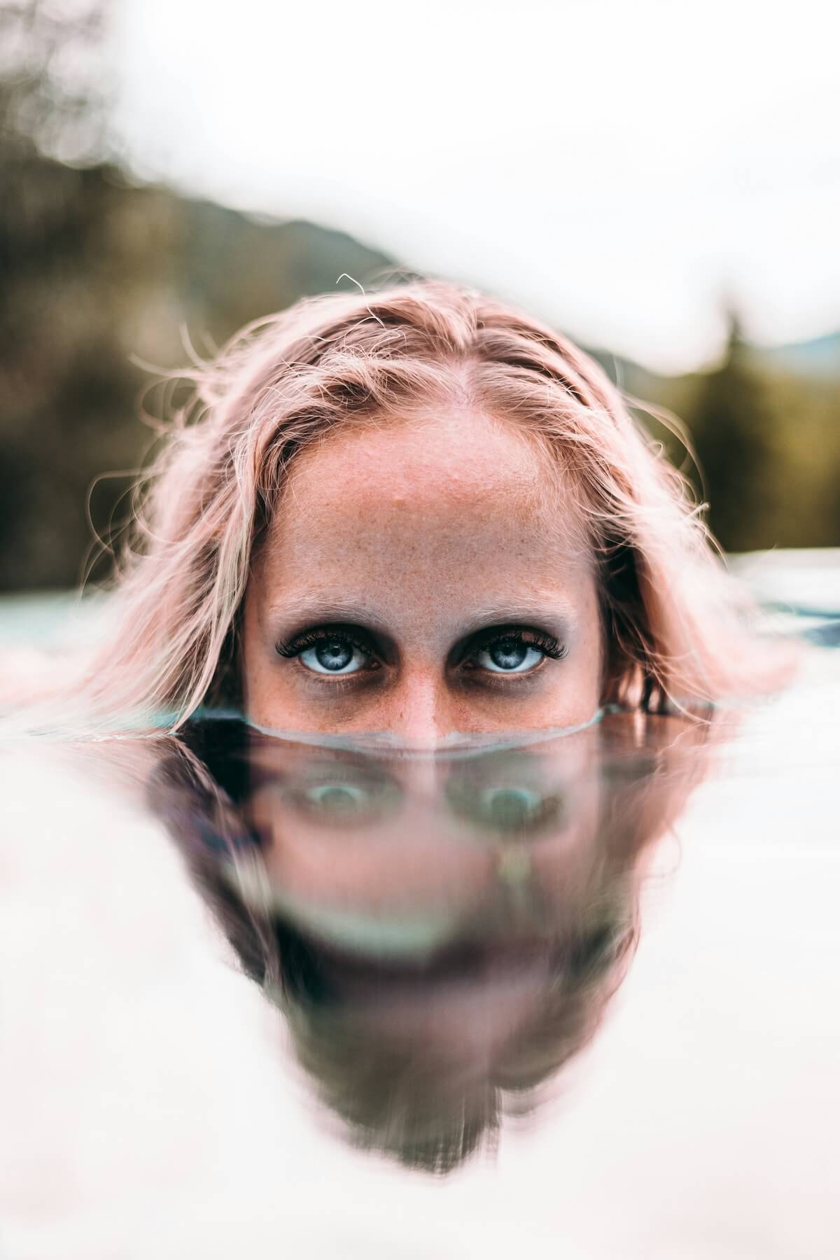 Unsplash: Woman in water up to face in pool by Lawless Capture
