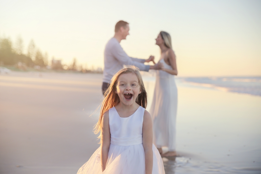 Young girl photoboming a picture of her parents.