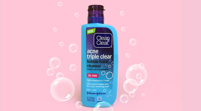 Clean & Clear's new Bubble Foam Cleanser on a pink background surrounded by bubbles