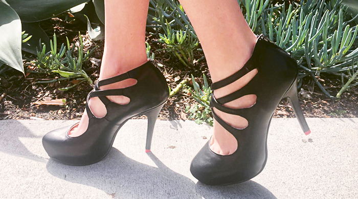 Black pumps on the sidewalk