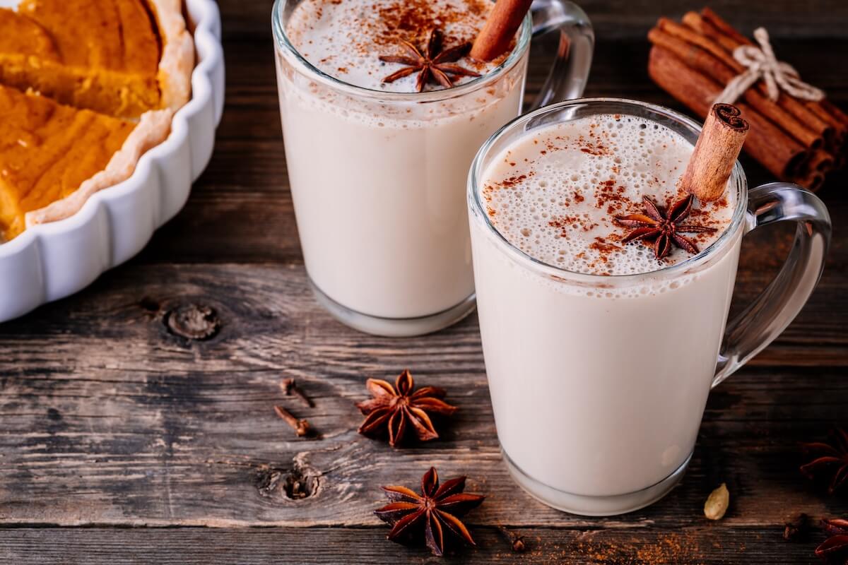 Shutterstock: Homemade Chai Tea Latte with anise and cinnamon stick in glass mugs with pumpkin pie on wooden rustic background