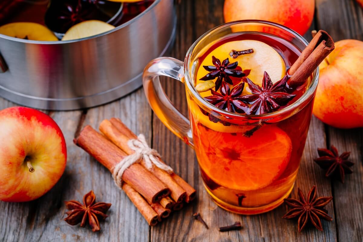 Shutterstock: Hot mulled apple cider with with cinnamon sticks, cloves and anise on wooden background