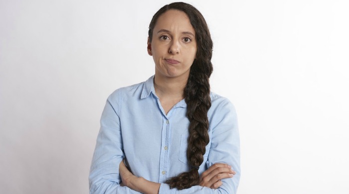 woman with braid looking annoyed