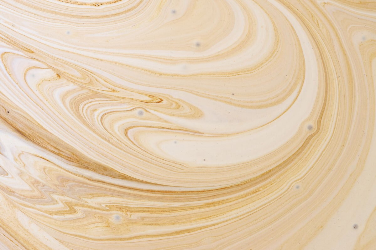 Shutterstock: Close-up abstract caramel shapes latte art in coffee. Liquid texture background macro.