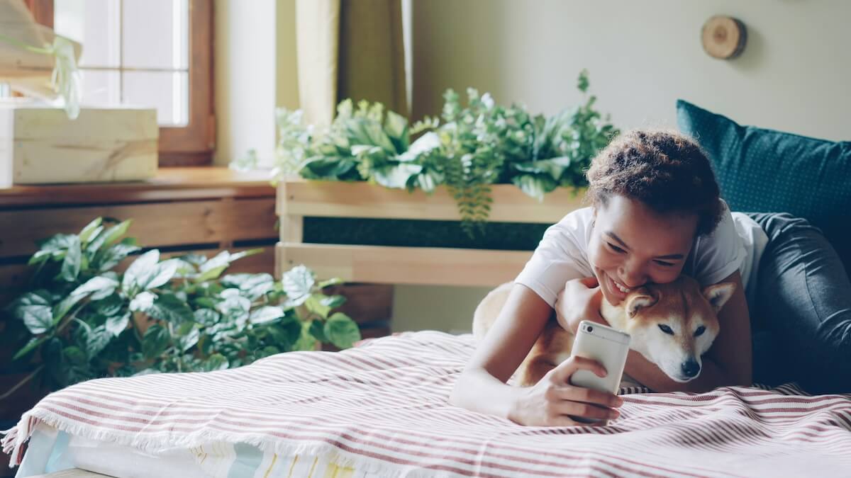 Unsplash: Young woman taking selfie with dog by vitaly gariev