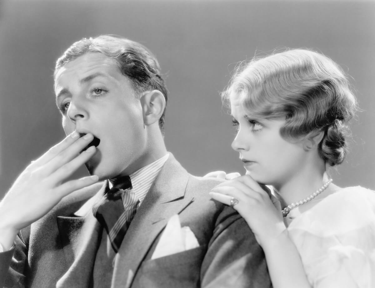 Shutterstock: Man looking bored with his woman