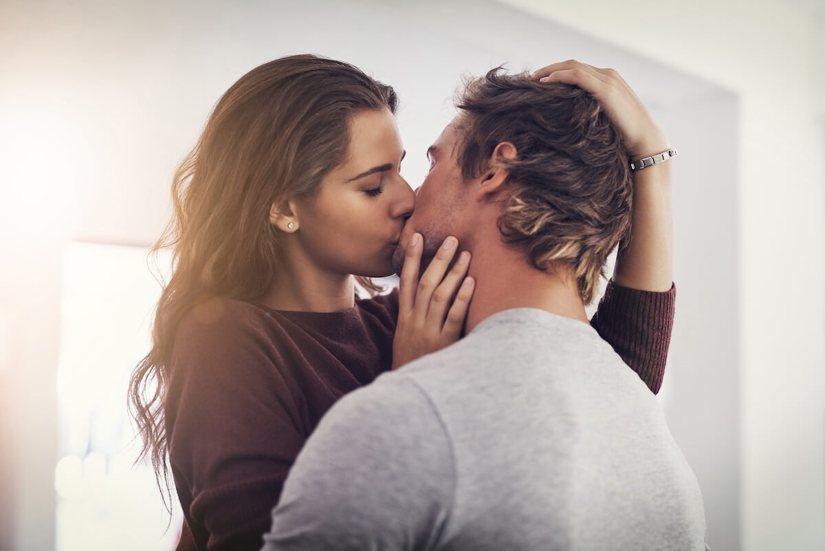 Unsplash: Couple, love and kissing in home for romantic bond, quality time and care together. Young man, woman and kiss for romance of lovers in happy relationship, intimate moment and passionate affection