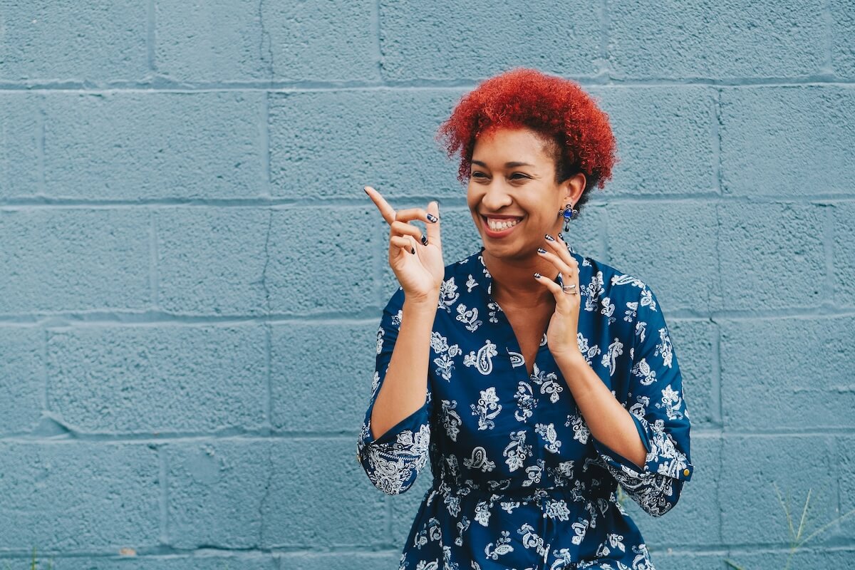 Unsplash: Smiling happy woman against wall by eye for ebony