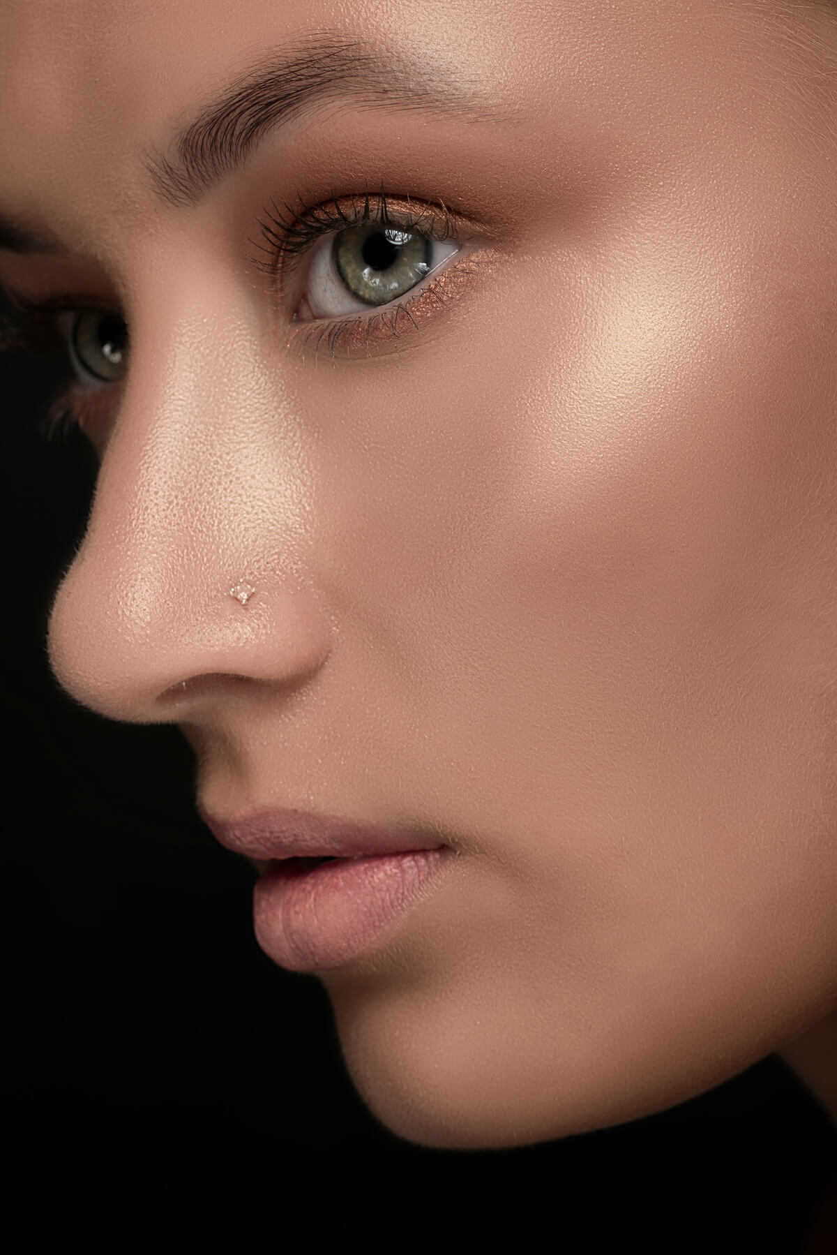 Unsplash: Woman wearing highlighter makeup on cheeks by Milad Shams