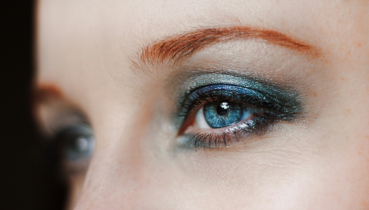 Unsplash: Woman with blue eyeshadow by Tom Swinnen