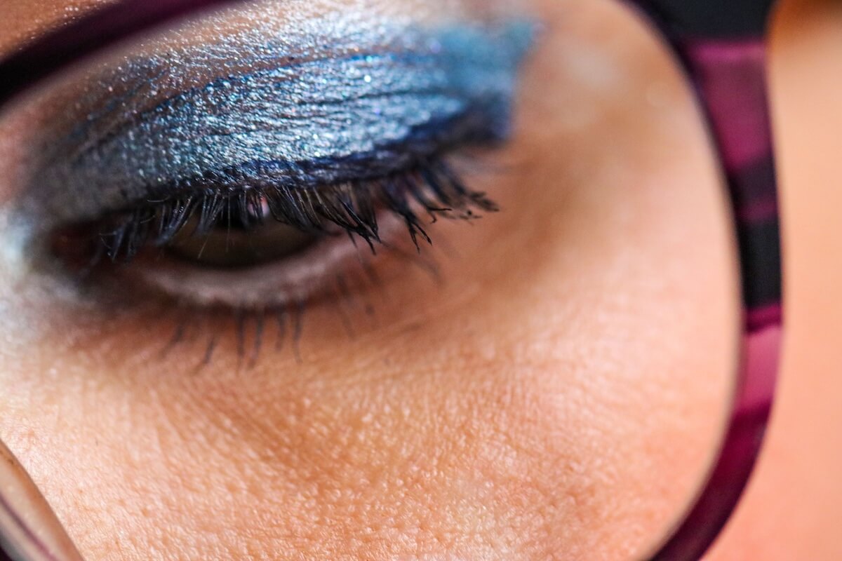 Shutterstock: A woman wearing glasses, possessing striking eyes that convey a range of emotions.