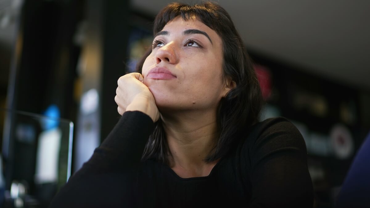 Shutterstock: A pensive hispanic latin girl thinking. Young woman daydreaming pondering solution. A thoughtful South American person