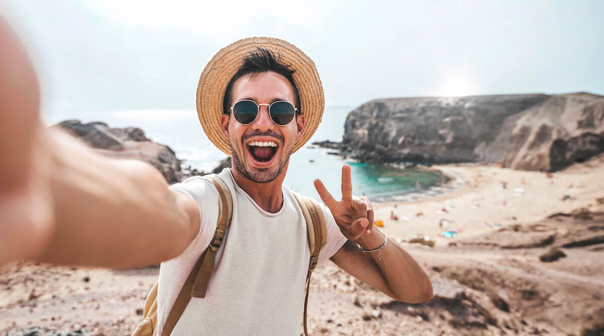 Shutterstock: Man taking travel selfie