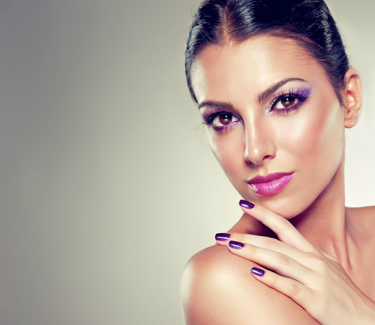 Shutterstock: Beauty girl model with violet manicure on the nails.