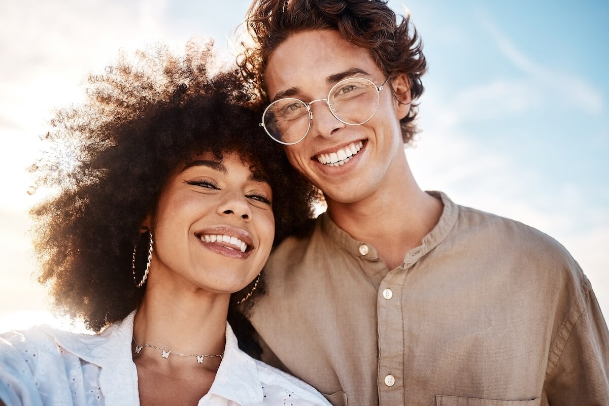 Shutterstock: Portrait of a young couple enjoying a day at the beach looking happy and in love. Portrait of a young couple enjoying a day at the beach looking happy and in love.