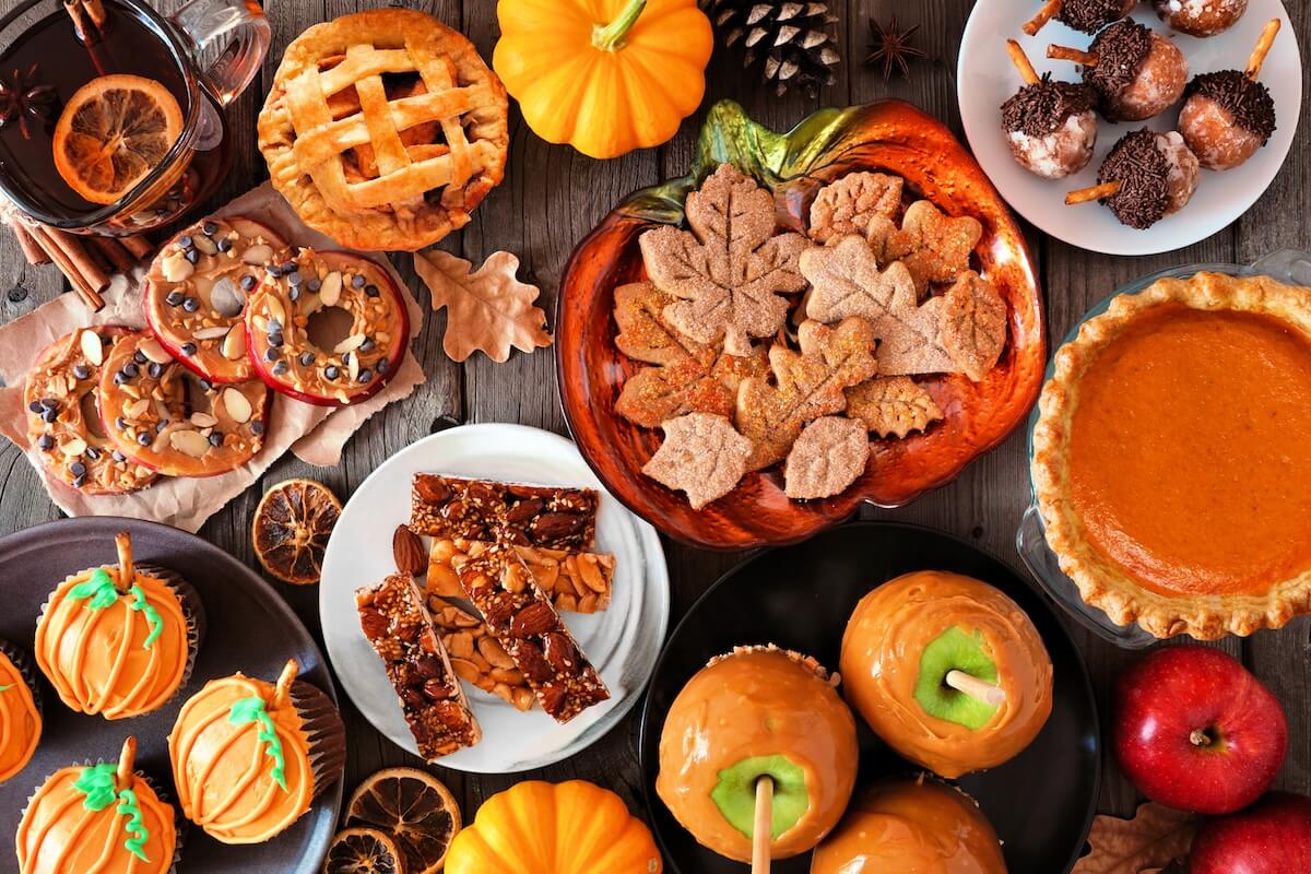 Shutterstock: Fall desserts table scene with a mixture of sweet autumn treats. Top down view over a dark wood background.