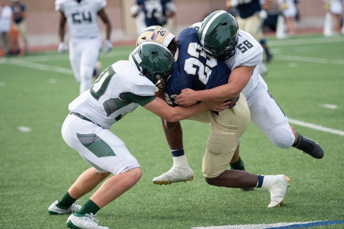 Shutterstock: Action photos of high school football players making amazing plays during a football game