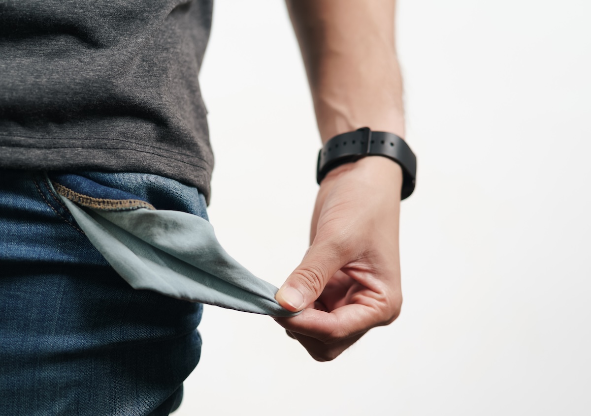 Shutterstock: Man turning out the jean pocket to showing empty pocket. bankrupt, bad economy, no money concept.