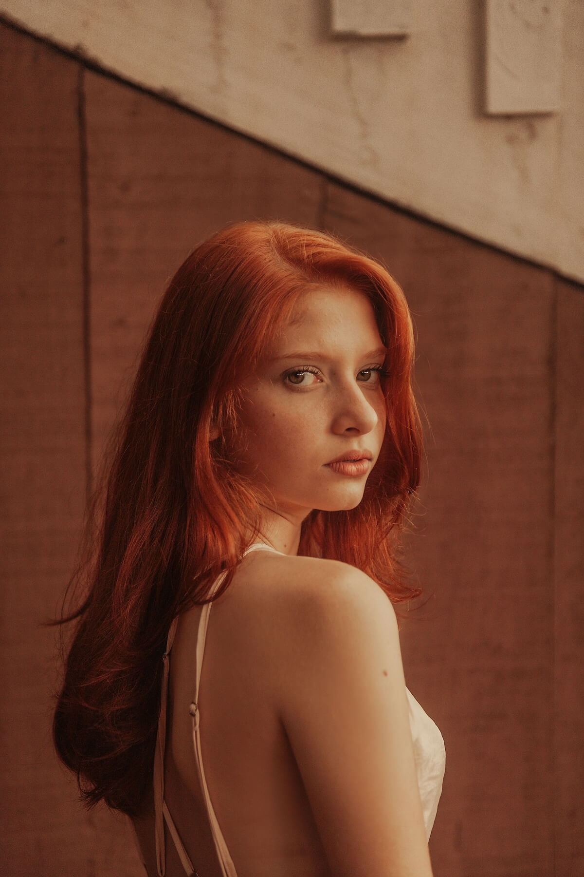 Unsplash: Red haired woman looking over shoulder by Gabriel Silverio