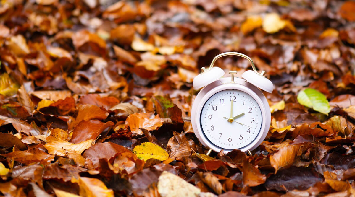 Shutterstock: Clock in fall leaves for the end of Daylight Saving Time