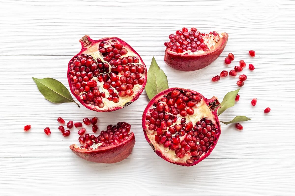 Shutterstock: Top view of fresh ripe pomegranate with half and pieces ready for eating.
