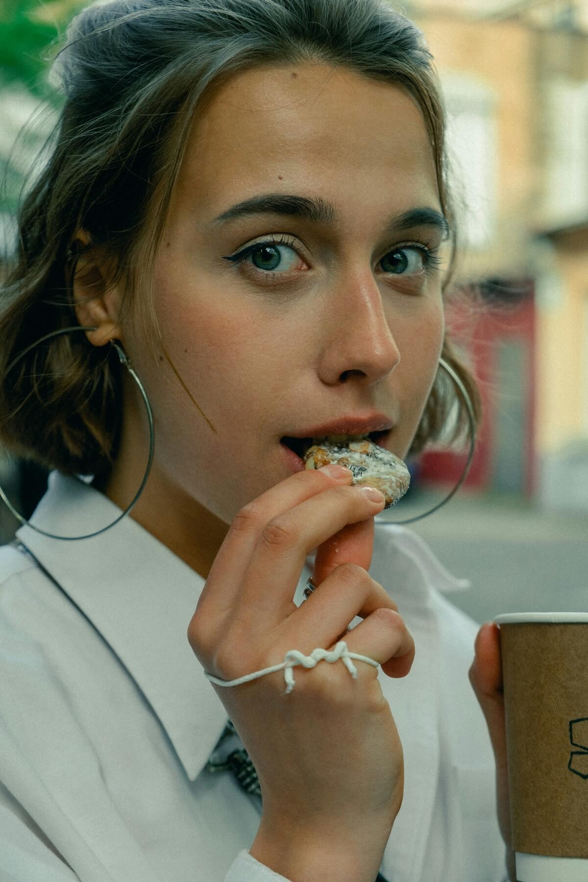 Unsplash: Woman nibbling on small cookie by Vicky Hladynets