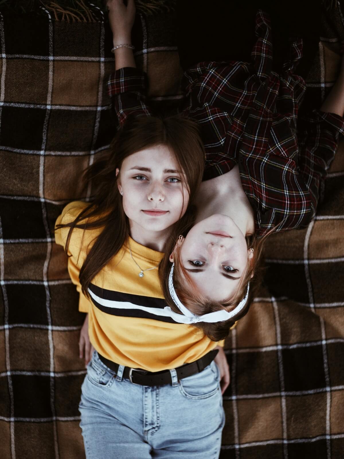 Unsplash: Sisters posing for photo on the ground