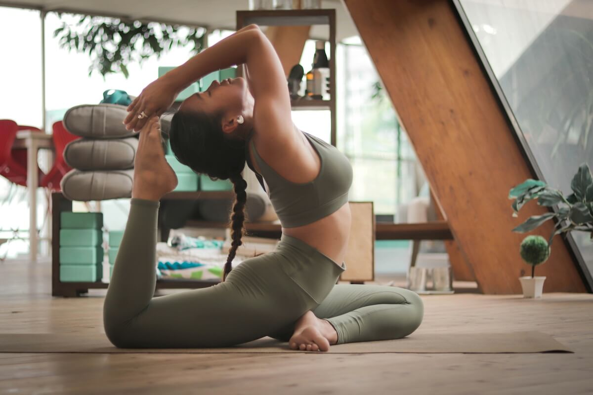 Unsplash: woman bending in touch yoga pose by Carl Barcelo
