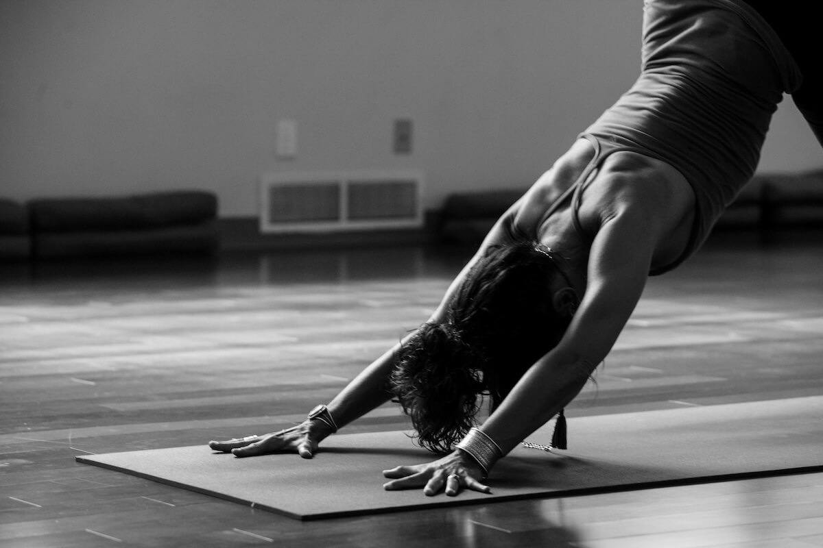 Unsplash: Woman bending in yoga pose in black and white by Rose Stewart