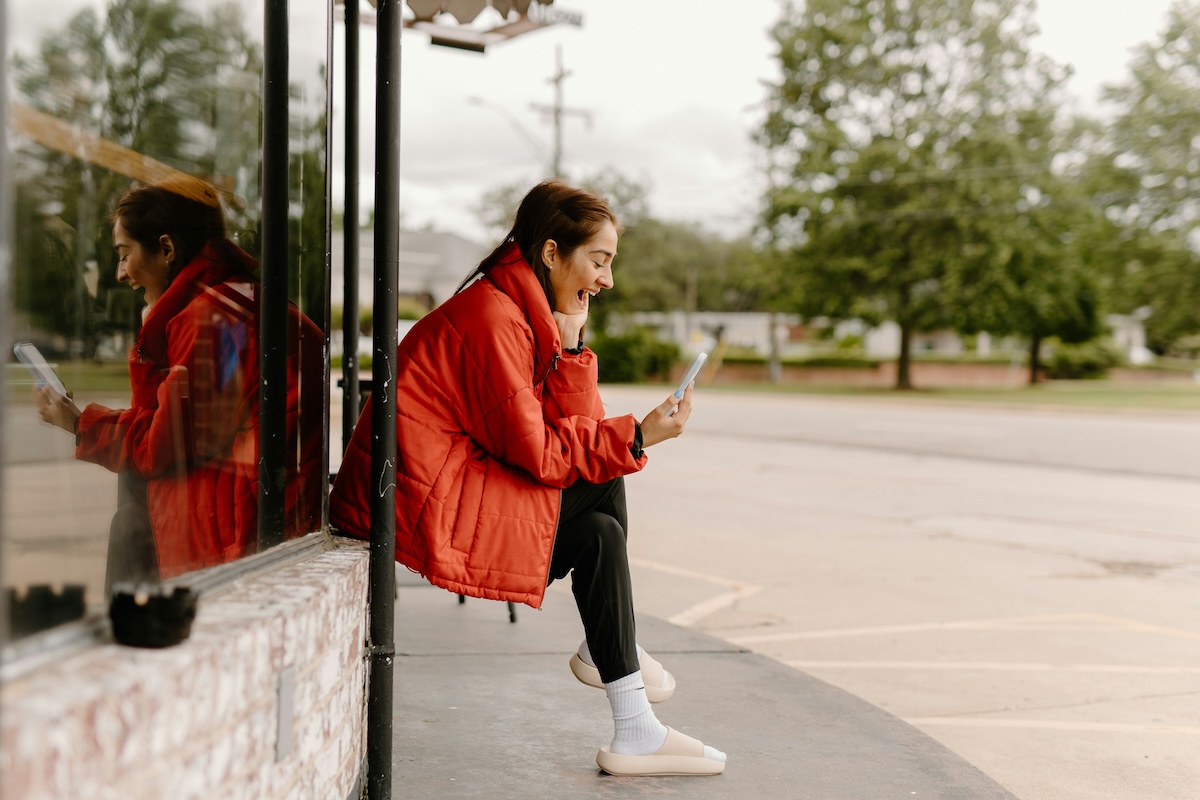 Unsplash: Woman smiling on facetime with phone by Brooke cagle