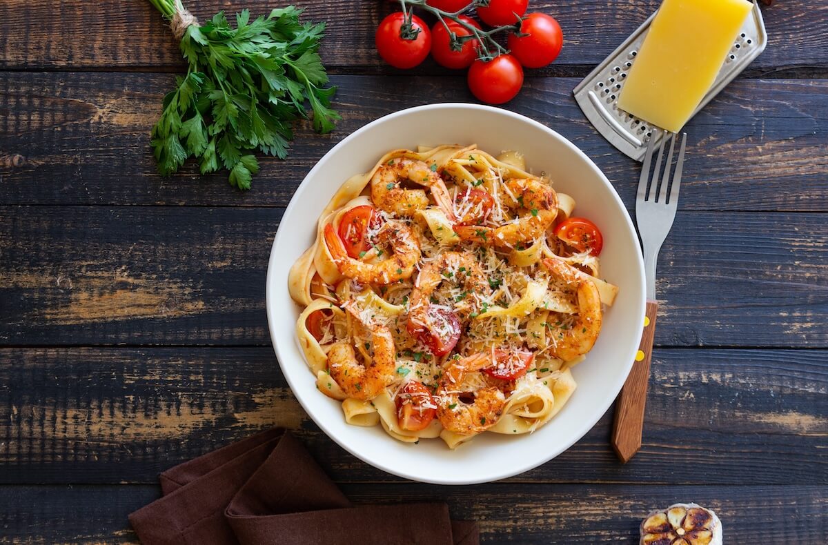 Shutterstock: Pasta with shrimps, tomatoes and cheese. Healthy eating. Italian food