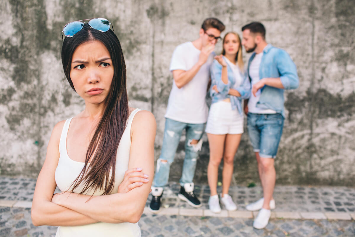 Shutterstock: Woman upset with friends taking behind her back and spreading rumors