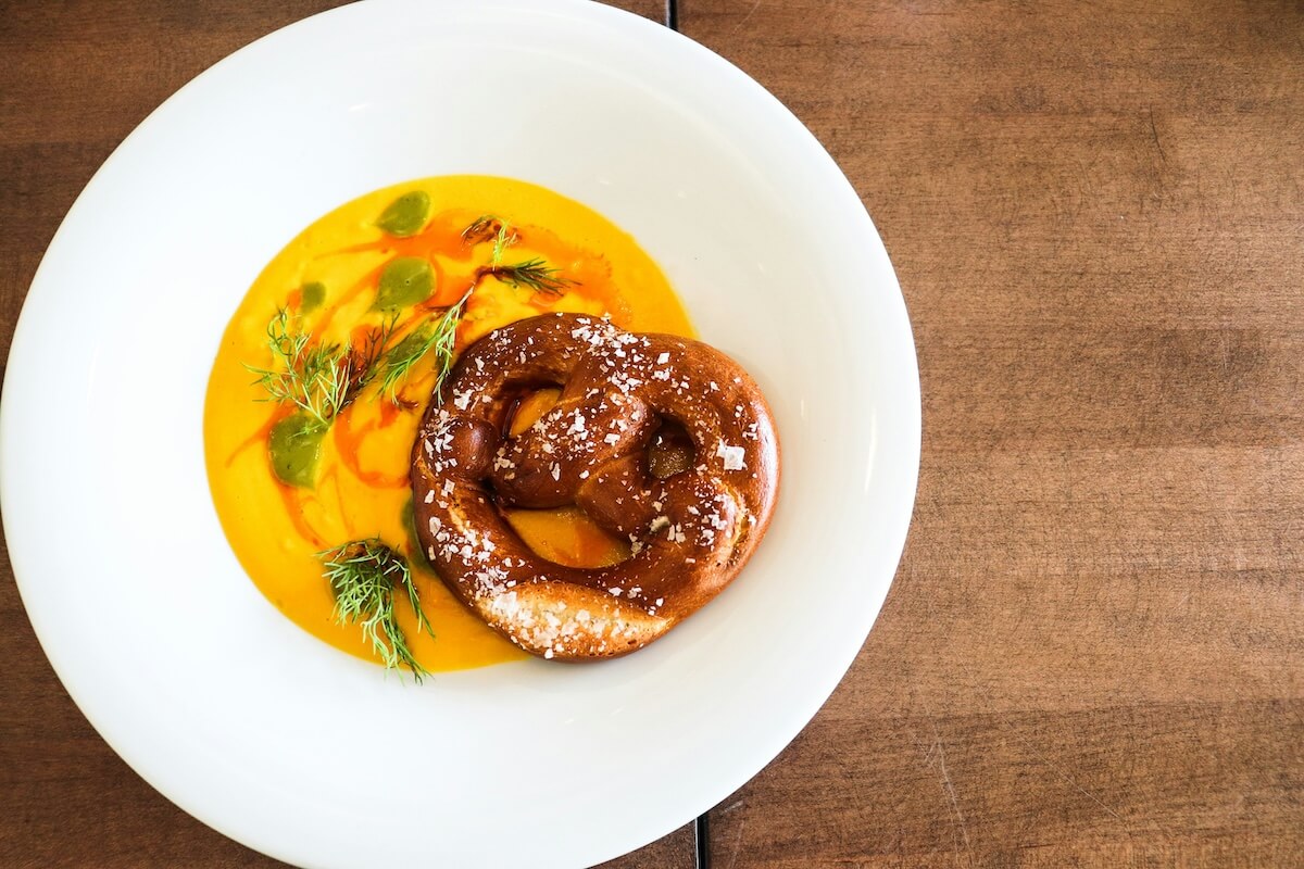Unsplash: Soft pretzel with soup by Aleisha Kalina