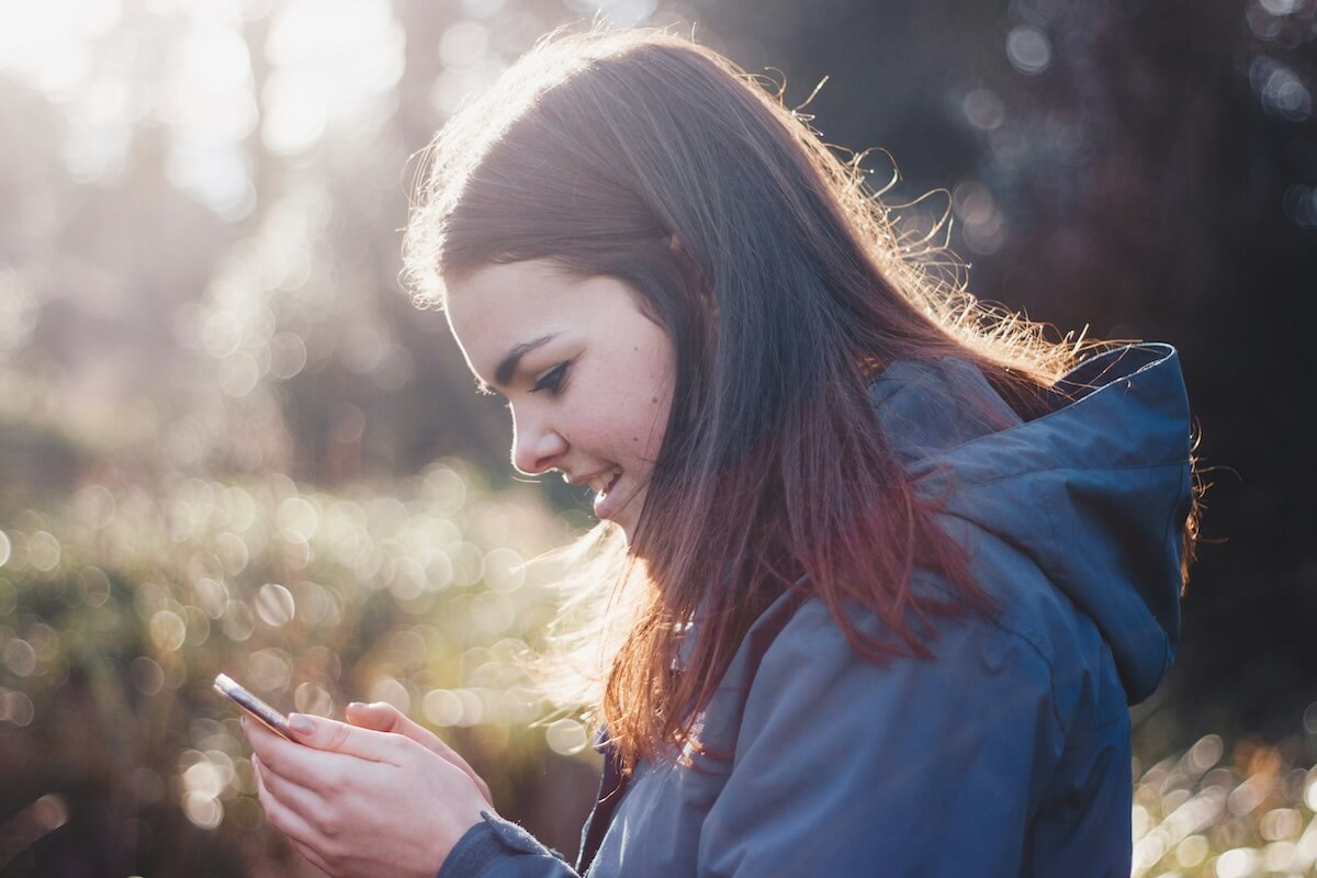 Unsplash: Woman shocked looking at phone by luke porter