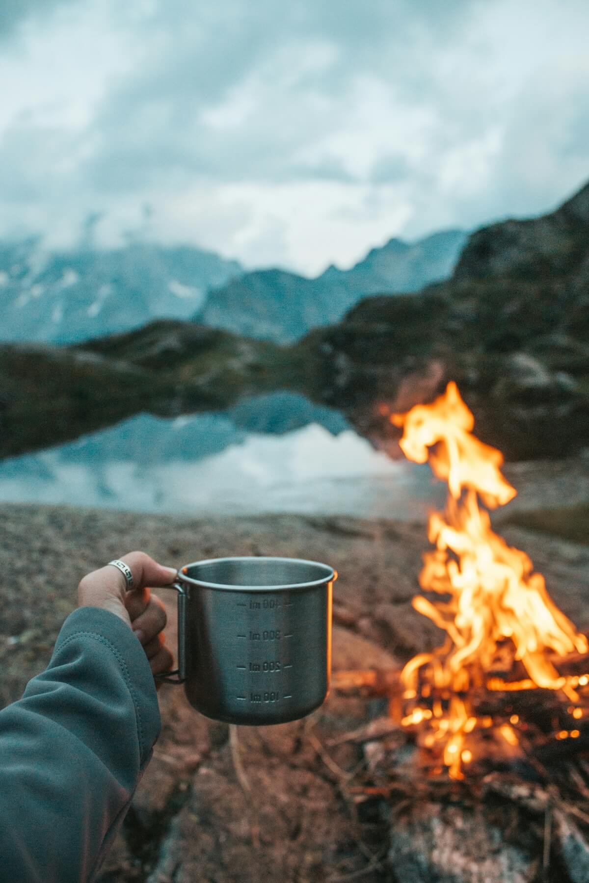Unsplash: Camping with cup and campfire by Laurine Bailly