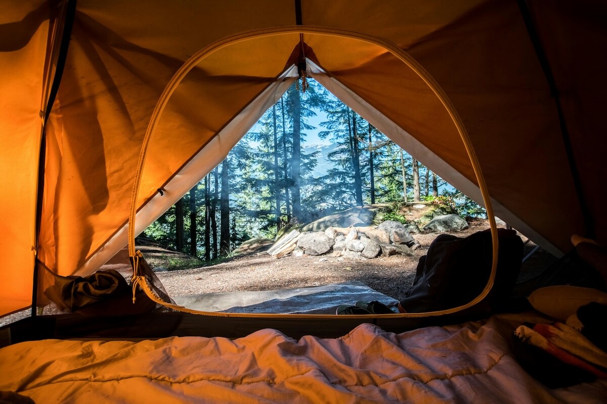 Unsplash: Looking out tent door by scott goodwill