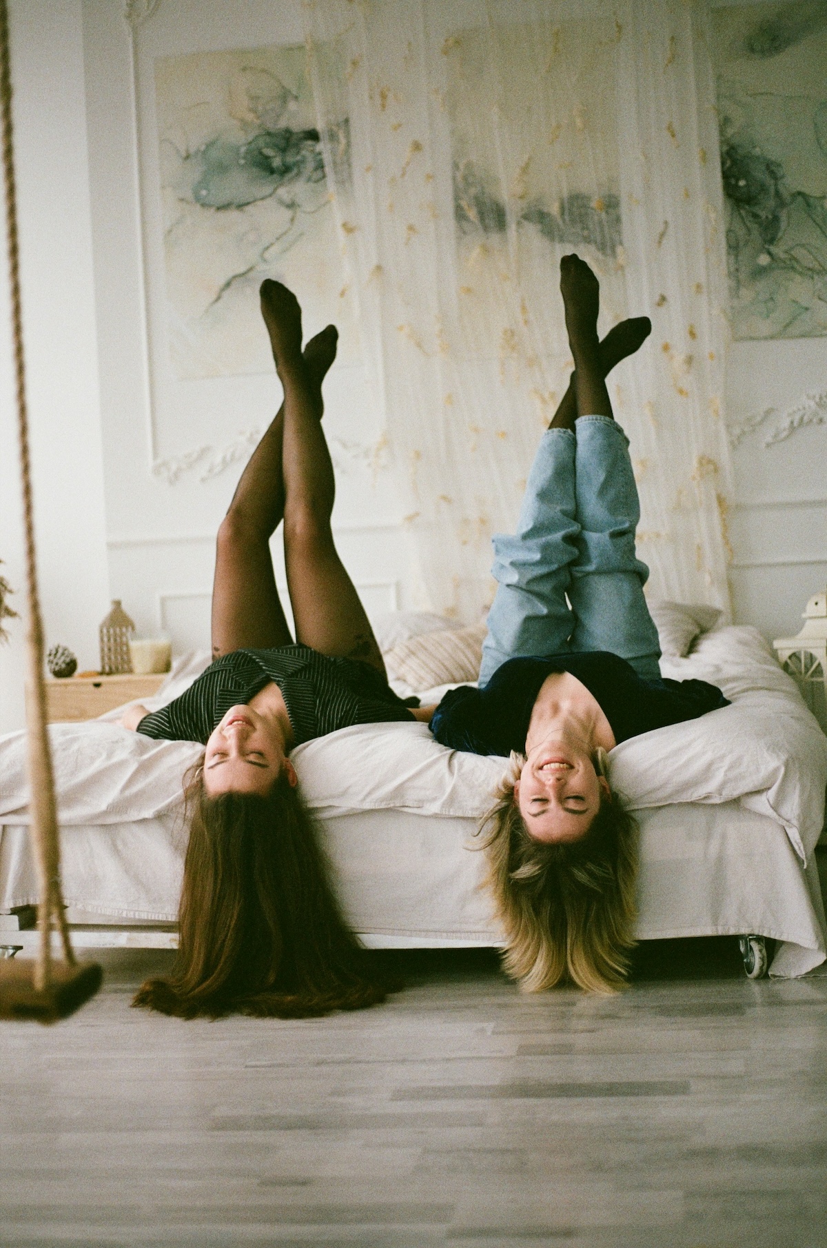 Unsplash: Sisters hanging out upside down in room by Olena Bohovyk