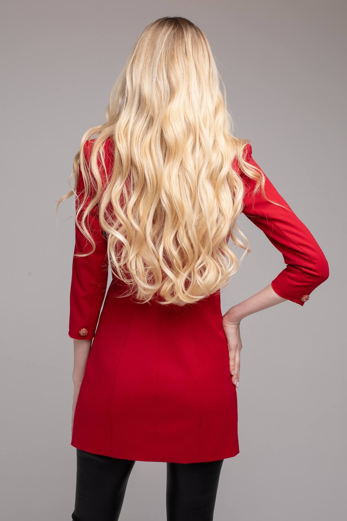 Shutterstock: Rear view of blonde woman posing in red dress.