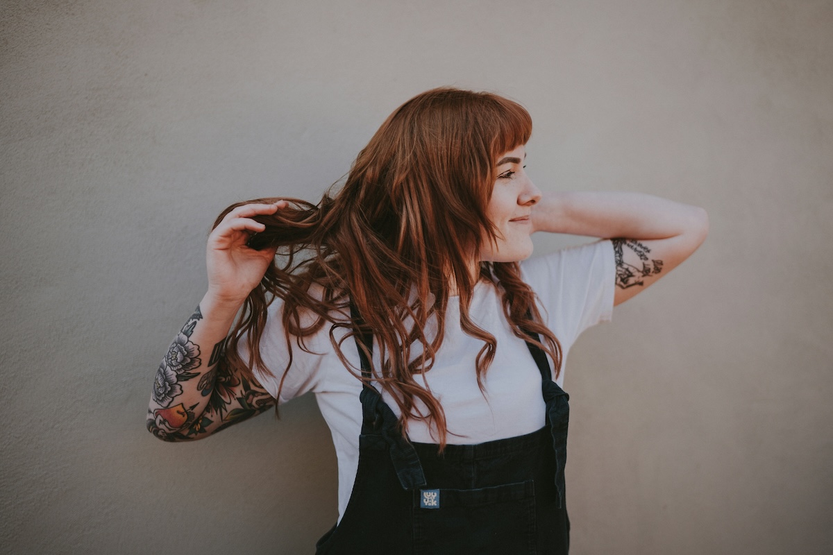 Unsplash: Smiling woman in overalls by Annie Spratt