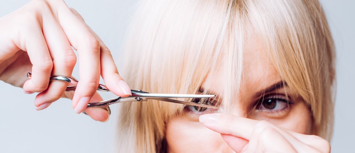 Shutterstock: Blonde girl cut forelock. Close up hairstyle with bangs. Hair care concept