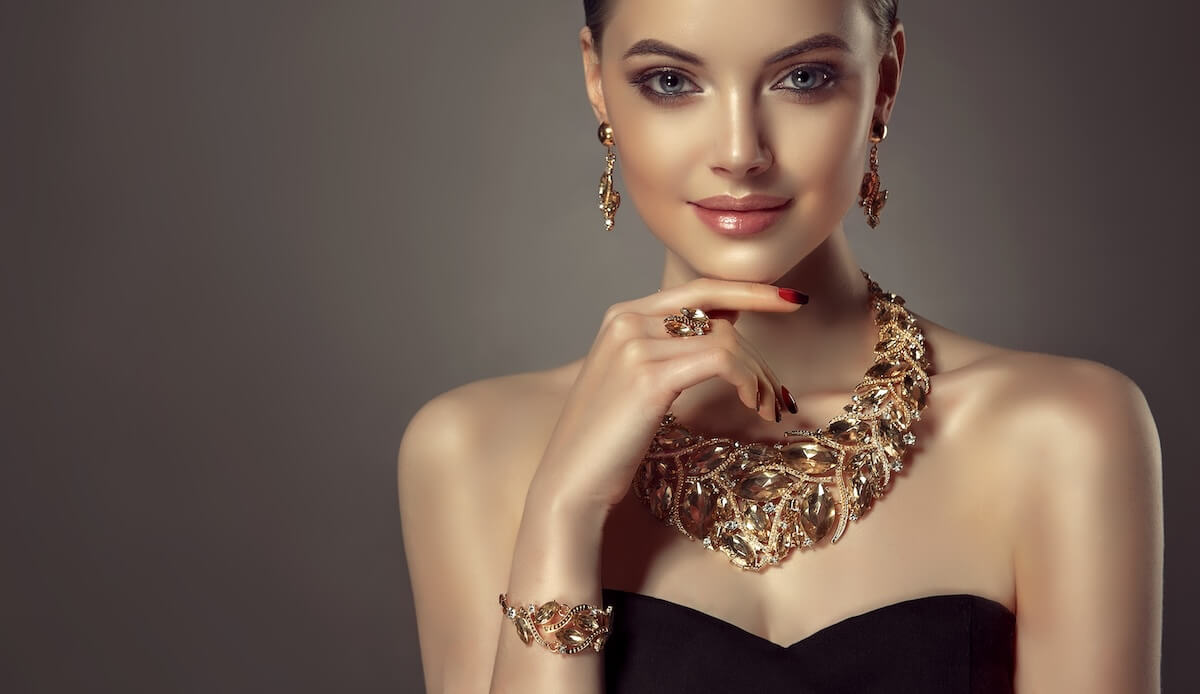 Shutterstock: Beautiful girl with set jewelry . Woman in a necklace with a ring, earrings and a bracelet. Beauty and accessories.