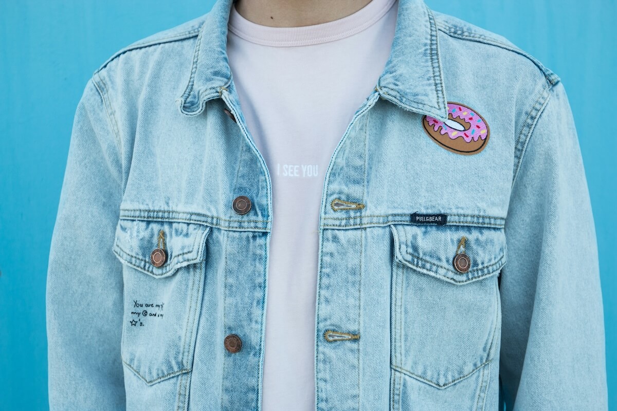 Unsplash: Close up on denim jacket with patches by Benjamin Voros