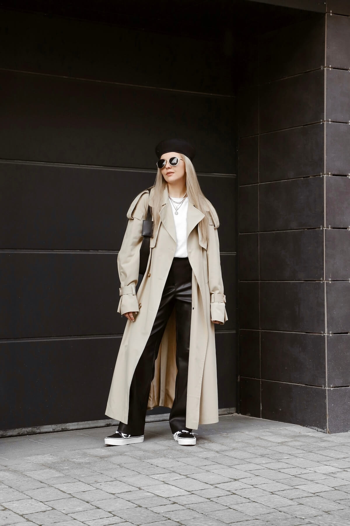 Shutterstock: beautiful blonde girl dressed in beige trench coat, leather black pant, beret, sneakers, bag, sunglasses, accessories, stylish fashion outfit, full length lifestyle model