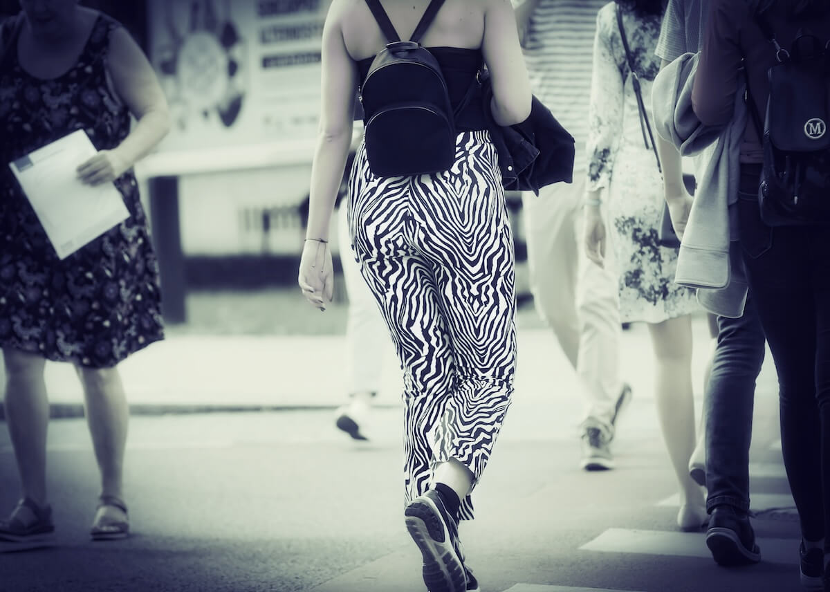 Unsplash: Woman wearing zebra print pants in crowd by iggii