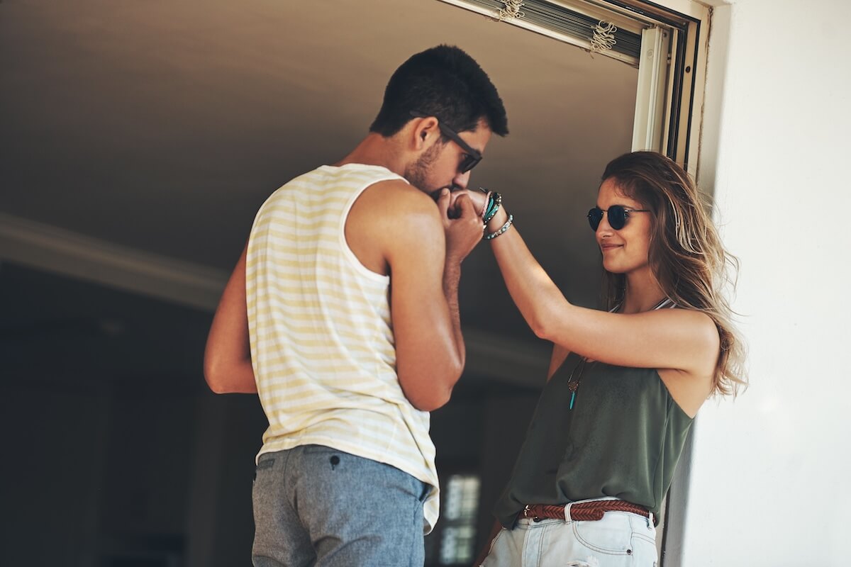 Shutterstock: Hes a hopeless romantic. Cropped shot of an affectionate young couple sharing an intimate moment outside on their balcony.
