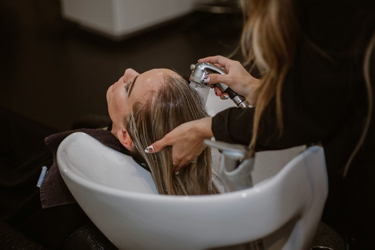 Unsplash: Woman getting hair washed by Lindsey Cash