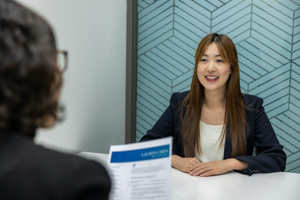 Unsplash: Woman looking professional in job interview by Resume Genius
