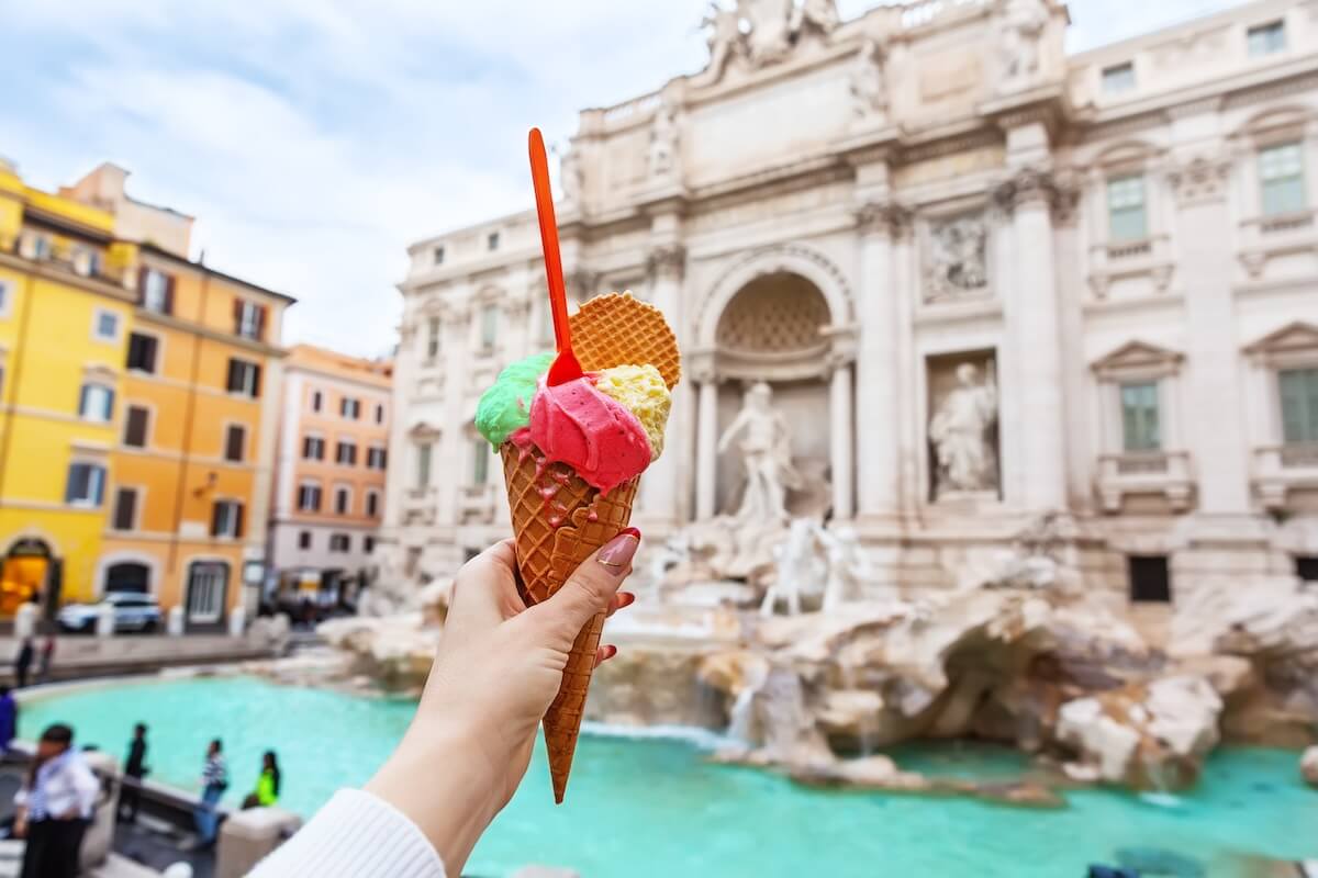 Shutterstock: Holding up gelato visiting Italy